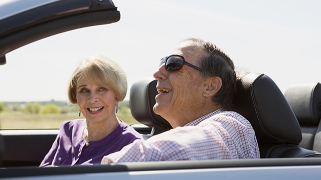 Un couple dans une voiture, souriant